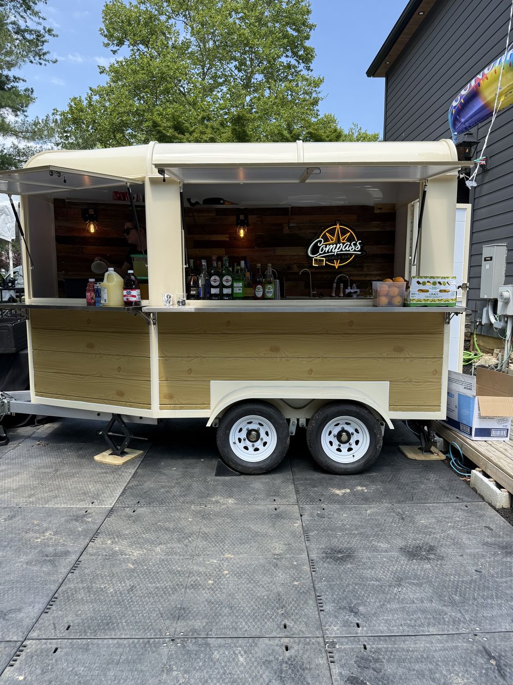 The Compass trailer bar open and serving at a backyard party