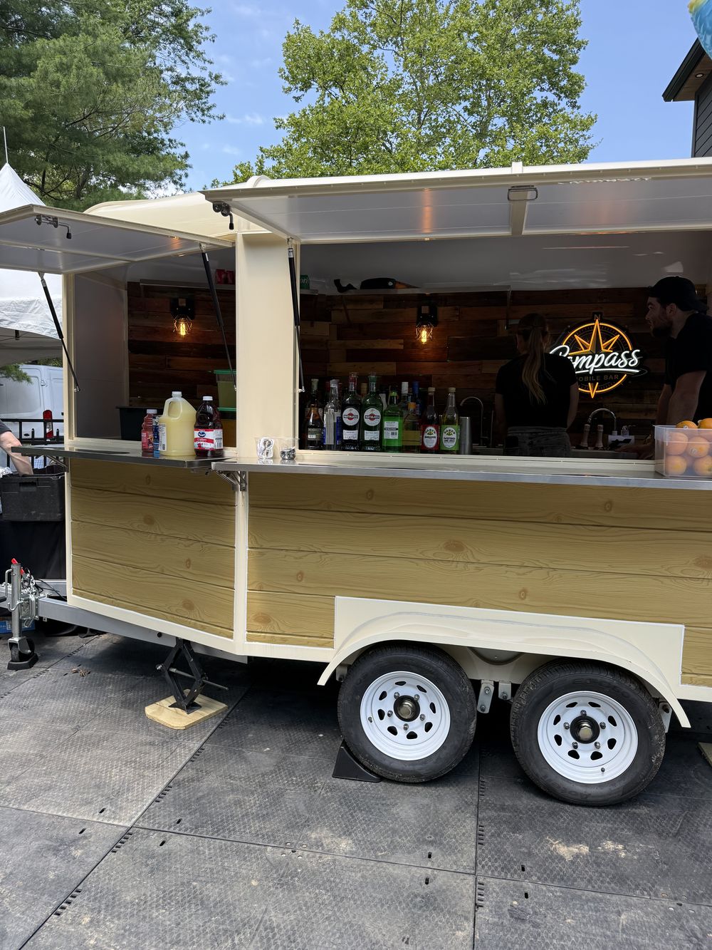 The Compass trailer set up for a backyard party with balloons and seating