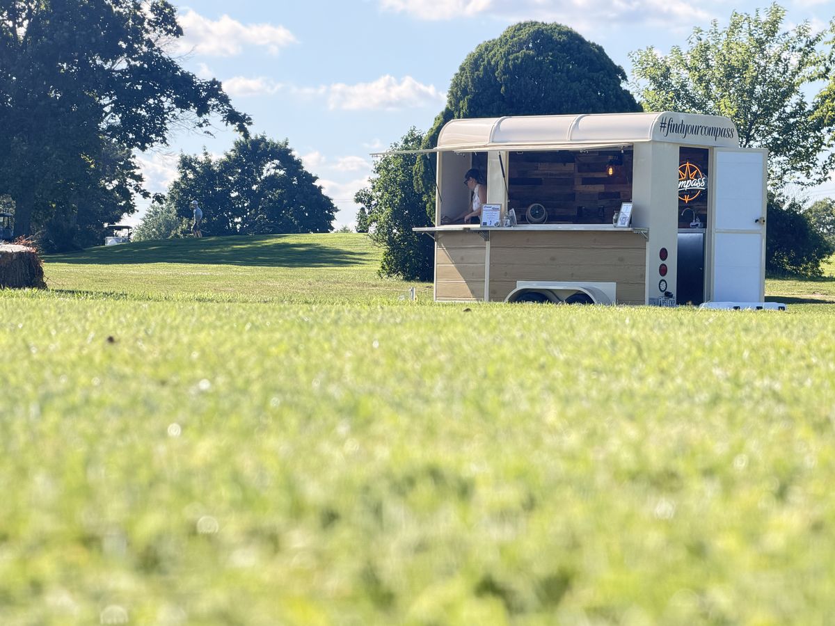 The Compass trailer across a New Jersey golf course with the findyourcompass hashtag on the roofline