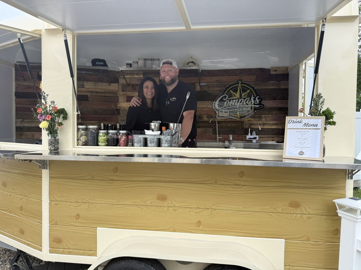 The Compass Mobile Bar crew at the serving window during the launch party