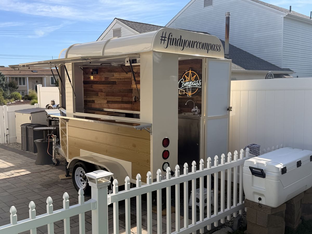 The Compass trailer leveled on a paver patio for a backyard birthday party