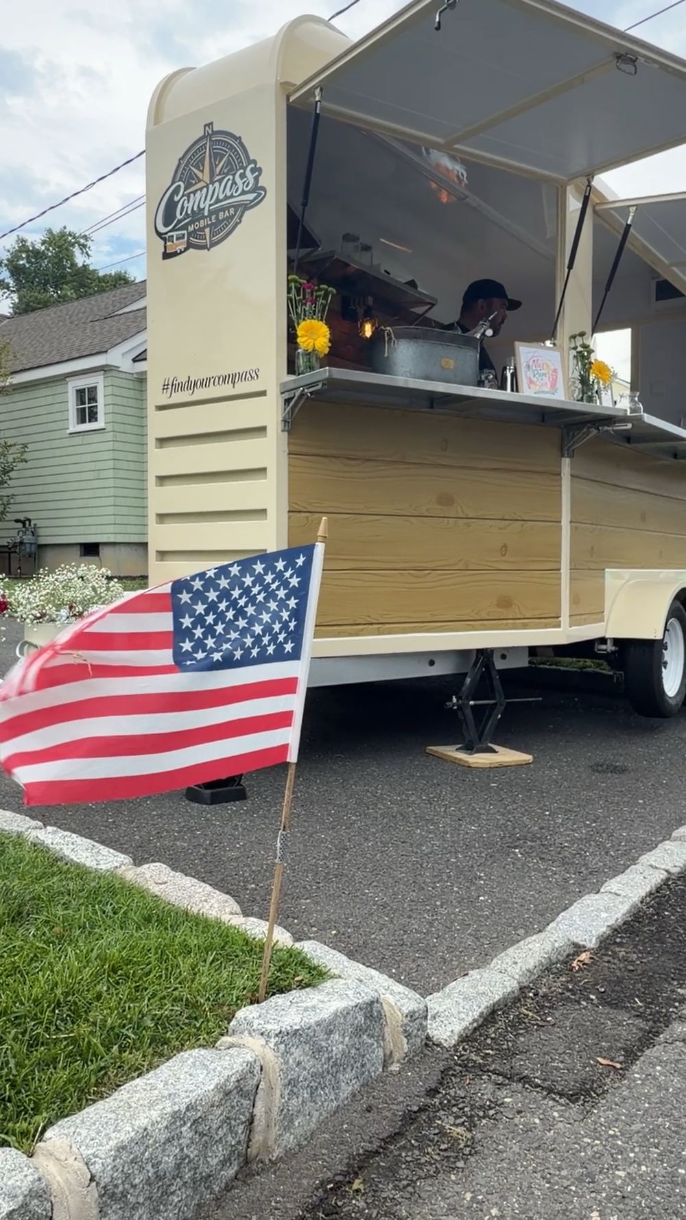 An American flag at the curb in front of the Compass Mobile Bar at the Narrumson Road block party in Manasquan
