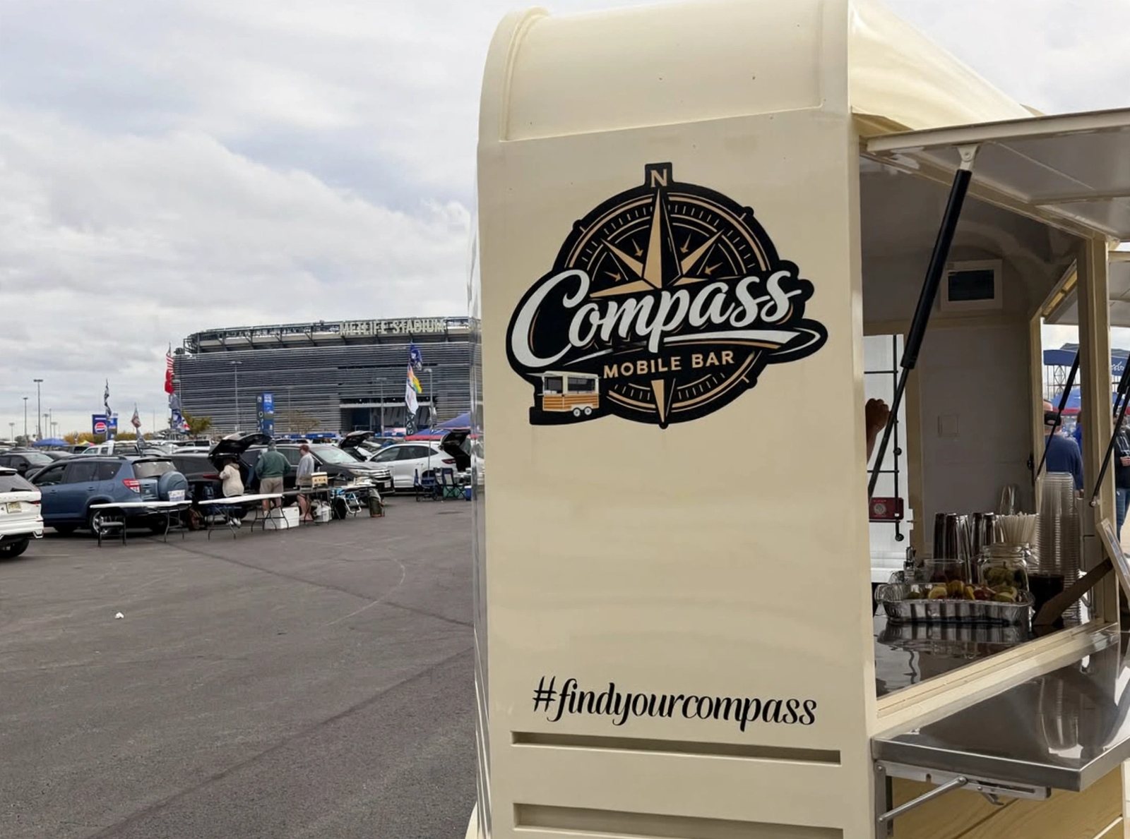 The Compass Mobile Bar trailer parked at MetLife Stadium Lot J3 on a Giants gameday