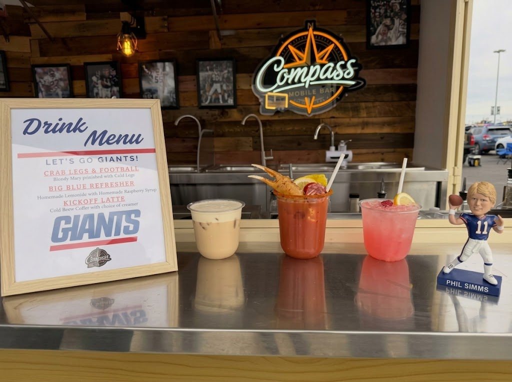 The Compass trailer serving window decked out with Giants decor, signed photos, and a gameday menu