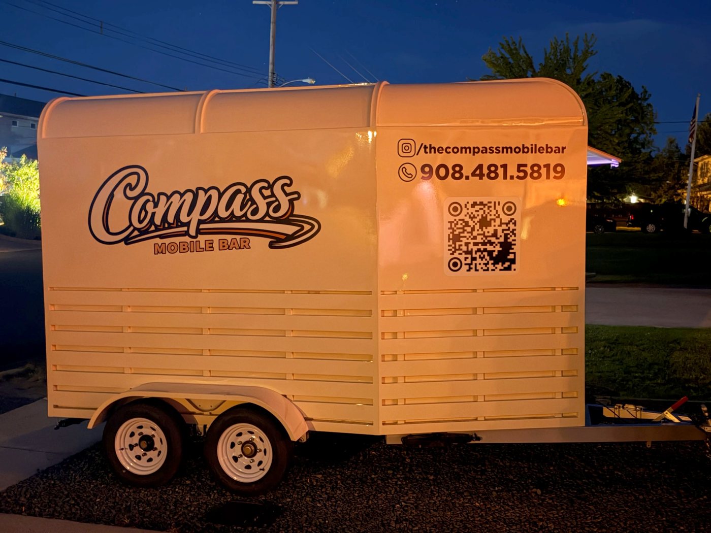 Trailer side profile at night with contact info and QR code