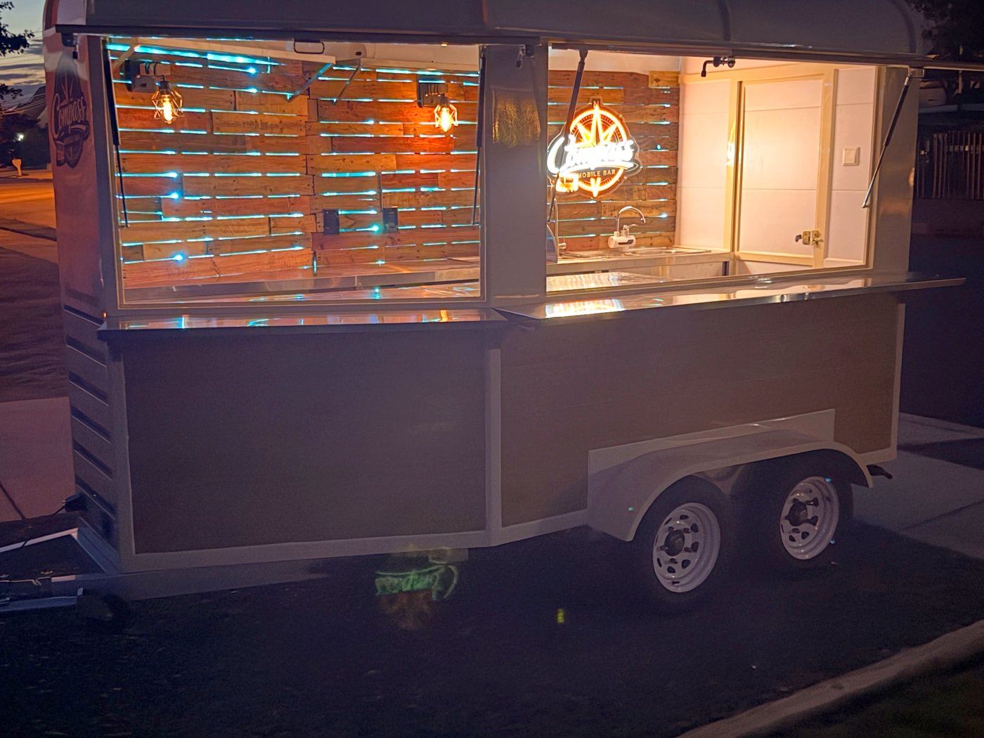 Backbar wall lit with LEDs behind the reclaimed wood at night
