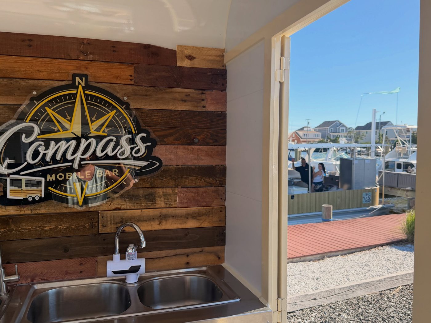 Neon Compass sign over the double sink